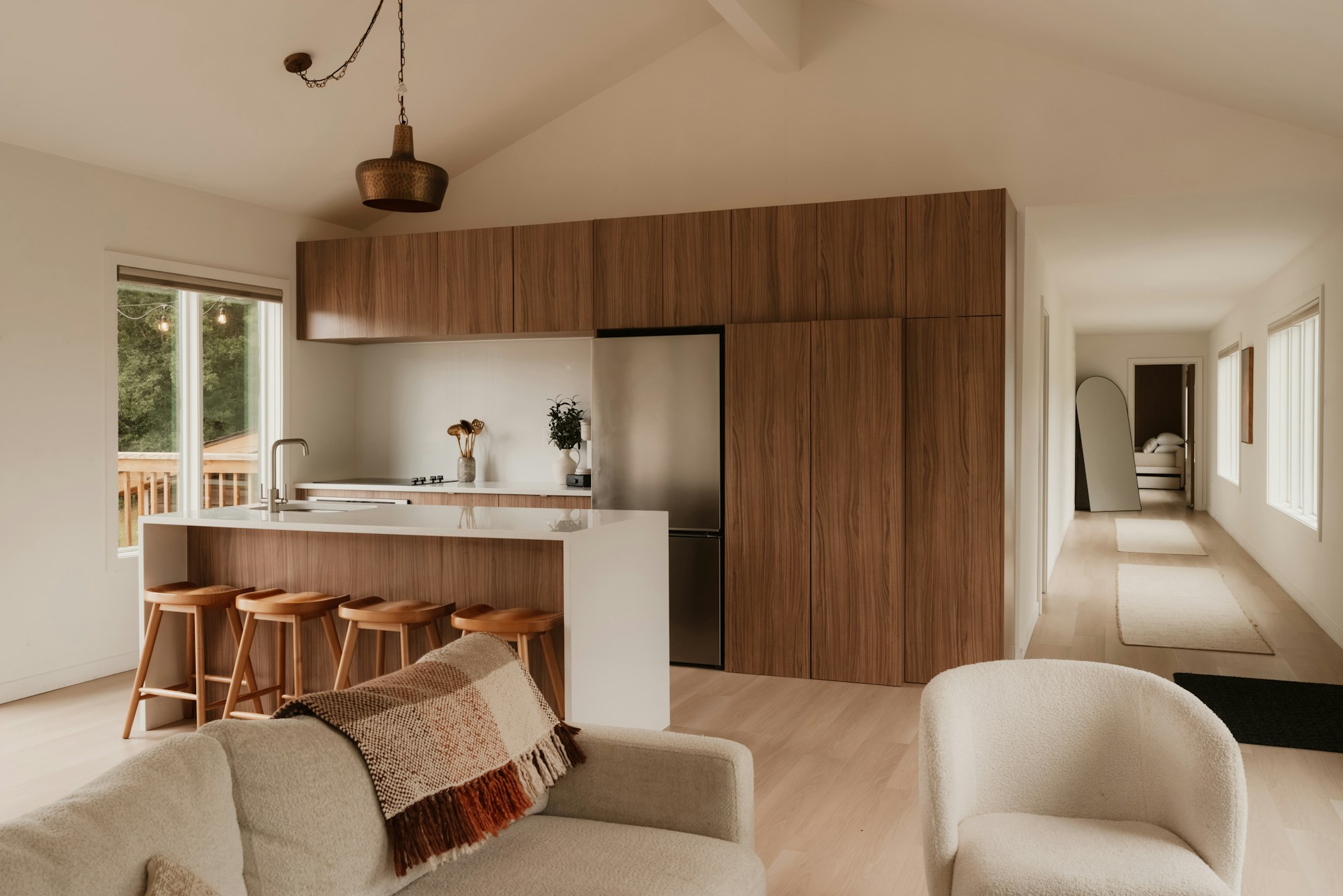 Warm wood kitchen with sunlight, considered storage and natural materials